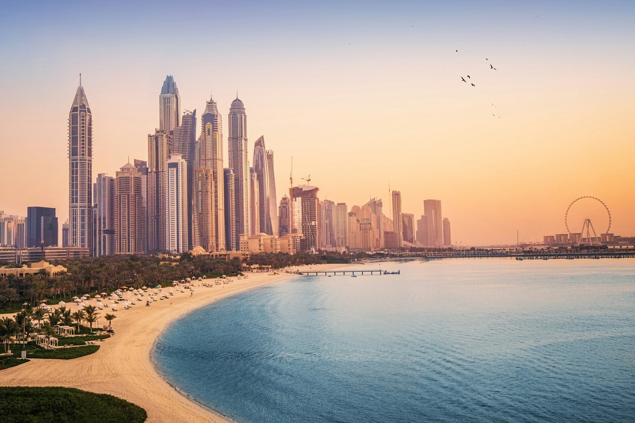 The beach and towers of Dubai Marina at sunset
