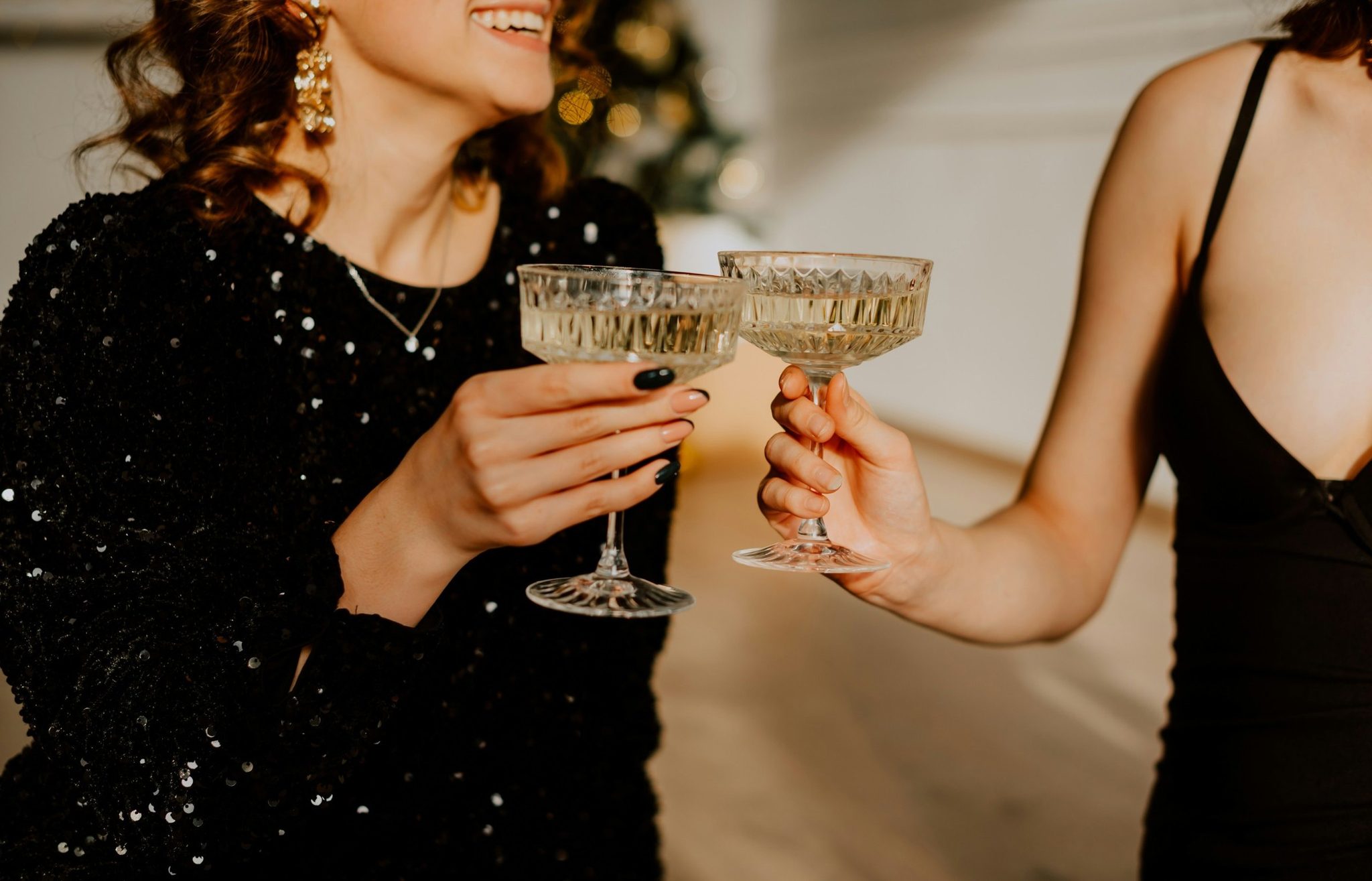 Two glasses of champagne raised in a toast